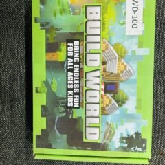 The green box on grey fabric, tilted, its cover a pixel landscape of blocky houses and trees, with a white WD-100 label stuck to one corner.